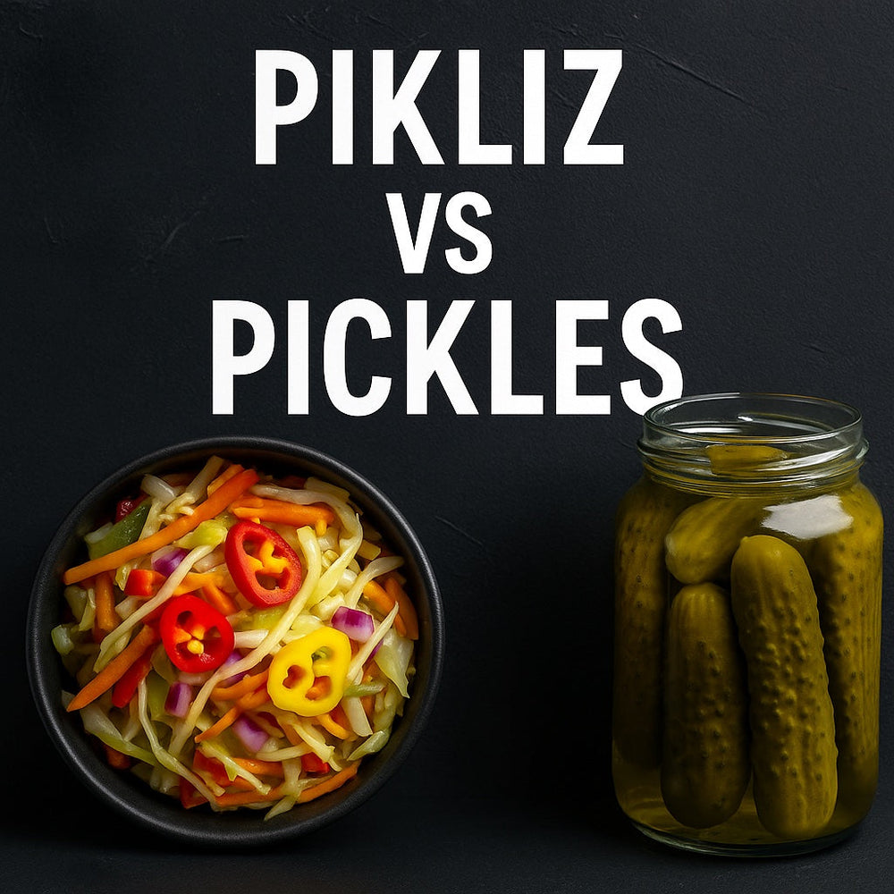 A bowl of colorful Haitian pikliz made with cabbage, carrots, peppers, and shallots sits beside a jar of plain pickles on a dark background with bold text reading 'Pikliz vs Pickles,' highlighting the difference between the two condiments.